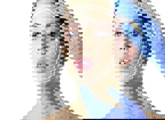 Woman with arrows drawn on her face showing lift directions, touched by gloved hands during face lift consultation