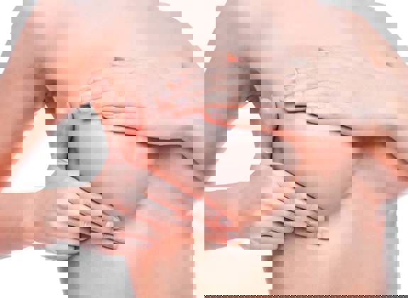 Woman undergoing breast examination for cosmetic breast surgery