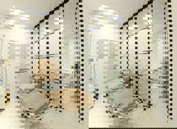 Aesthetic treatment room with advanced medical equipment at Opsis Clinical