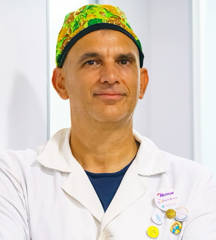 Portrait of Dr Ioannis Liapakis wearing surgical uniform at Opsis Clinical