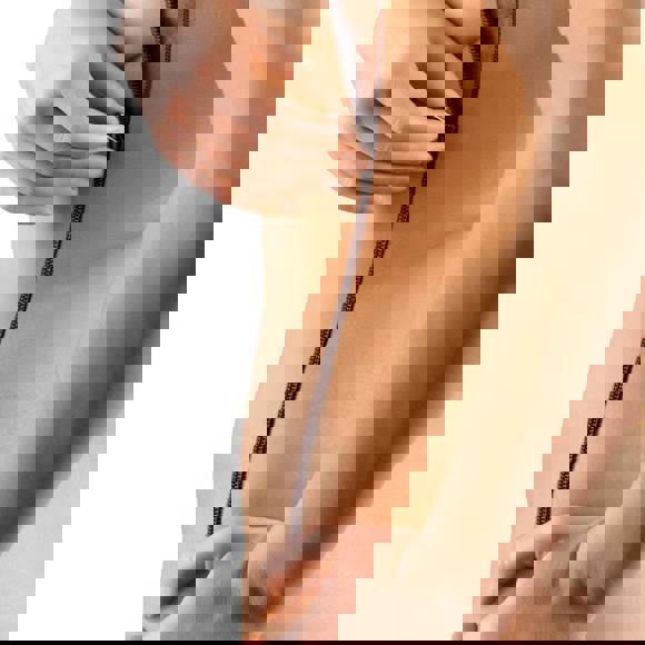 Conceptual image of a woman unzipping her skin along her side, symbolizing body transformation