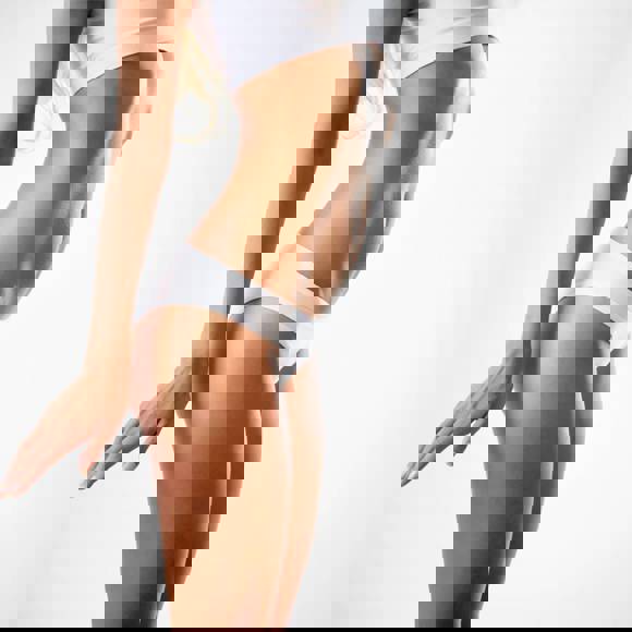 Female body contour after liposuction and skin tightening showing flat abdomen and defined waistline