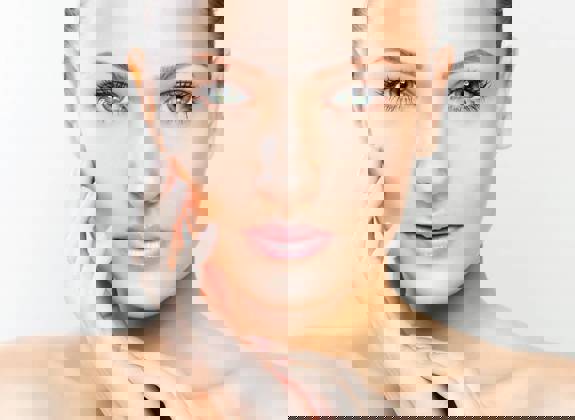 Portrait of a woman with smooth skin and natural makeup, representing facial aesthetics and treatments