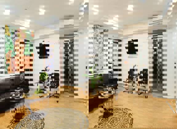 Cozy waiting area with modern decor and artwork at Opsis Clinical