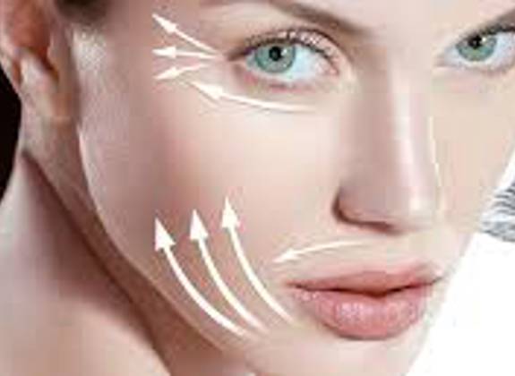 Close up of a woman receiving endermology facial treatment with device 