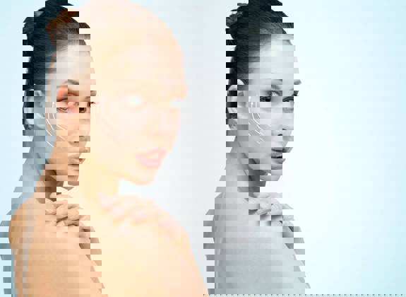 Portrait of a woman with clear skin and gentle upward contour lines on her cheek