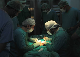 Surgeons performing an operation during a humanitarian medical mission